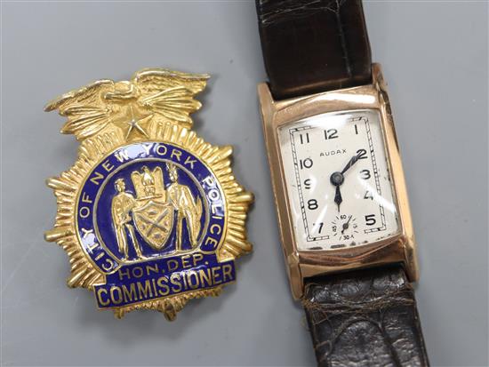 A Police badge - New York and a gold watch.